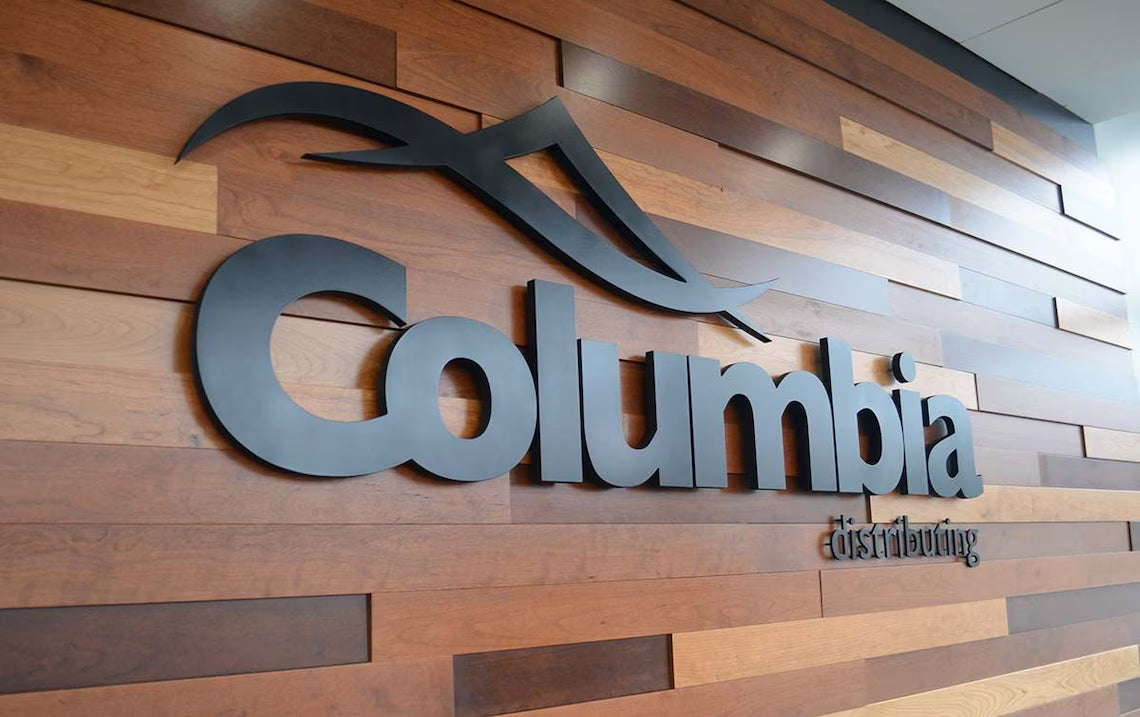 Columbia logo on a wooden panel wall