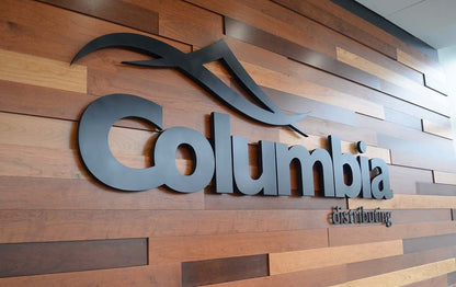 Columbia logo on a wooden panel wall