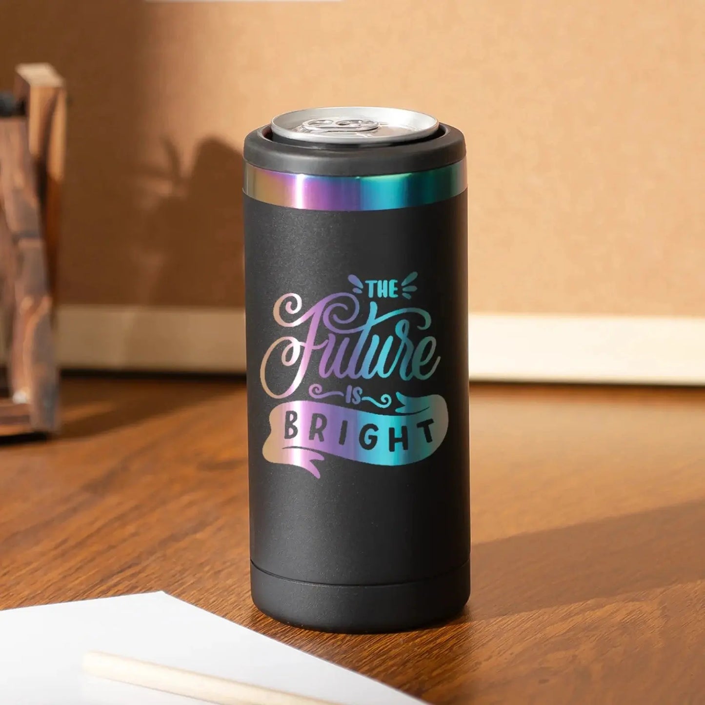 Black tumbler with 'The Future is Bright' text on a wooden surface