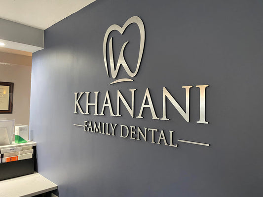 Khanani Family Dental logo on a wall in a dental office setting