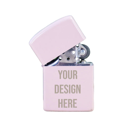 Pink lighter with 'Your Design Here' text on a light wooden surface with green leaves in the background