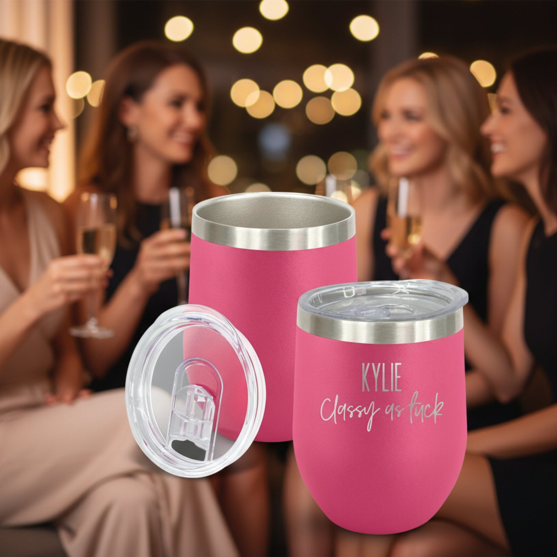 Pink insulated tumblers with silver lids on a white background