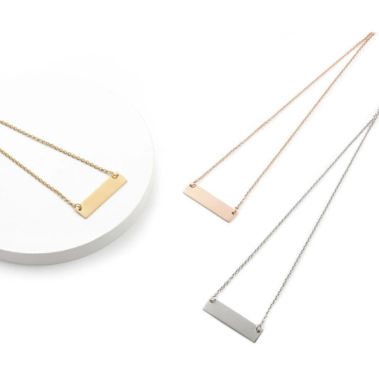 Three necklaces with horizontal bar pendants in gold, rose gold, and silver on a white background.