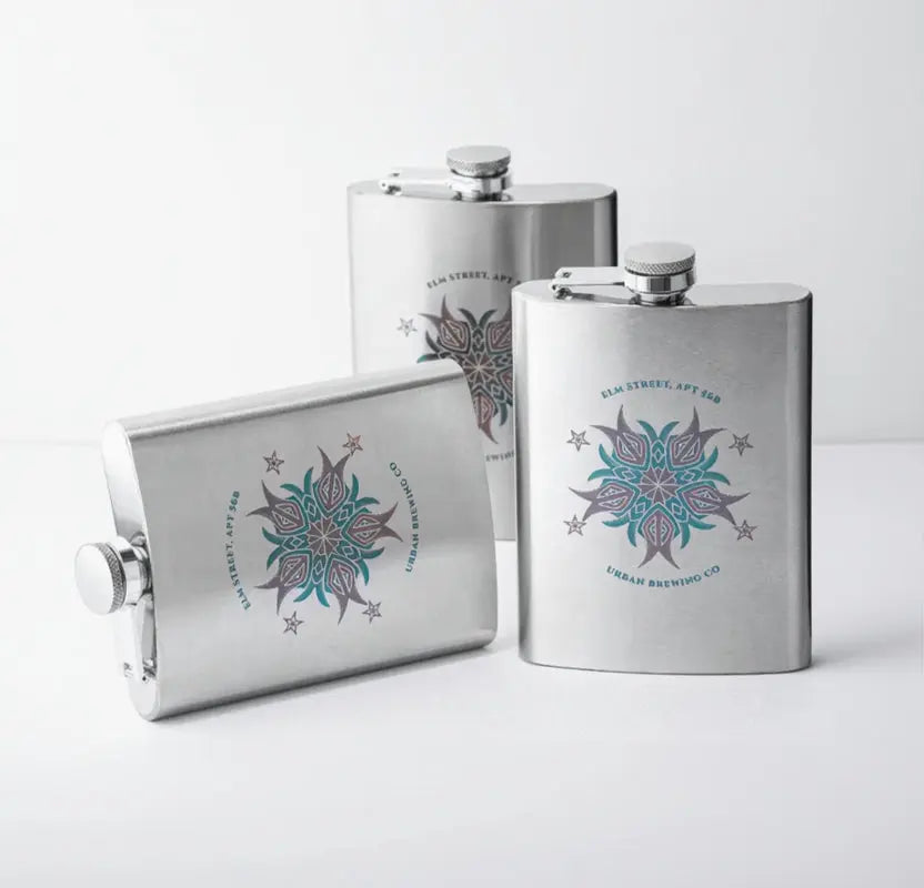 Three stainless steel flasks with decorative designs and text on a white background