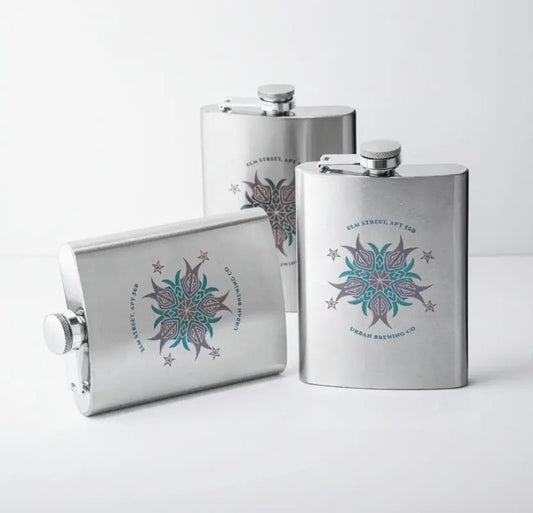 Three stainless steel flasks with decorative designs and text on a white background