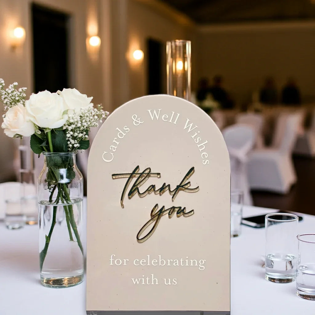 Wedding table decor with white roses in vase and thank you sign for cards and well wishes